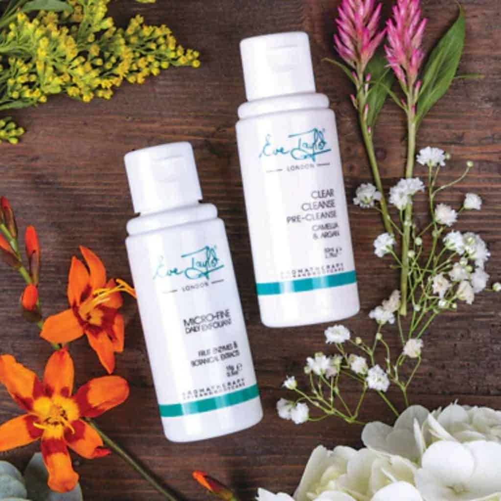 Eve Taylor skincare products displayed with flowers